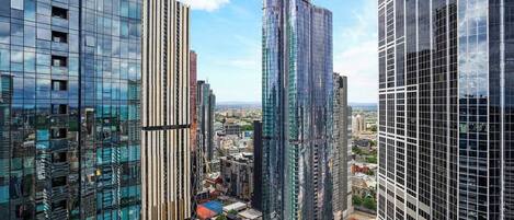 A high-rise urban area with modern glass buildings, some with vertical lines and others with a more traditional rectangular shape.