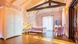 A bedroom with a bed, a chair, a desk, and a wardrobe. - Luxury 4-BR Villa with Pool, Ensuite Sauna, and Stunning Sea & Forest Views (Višnjan)