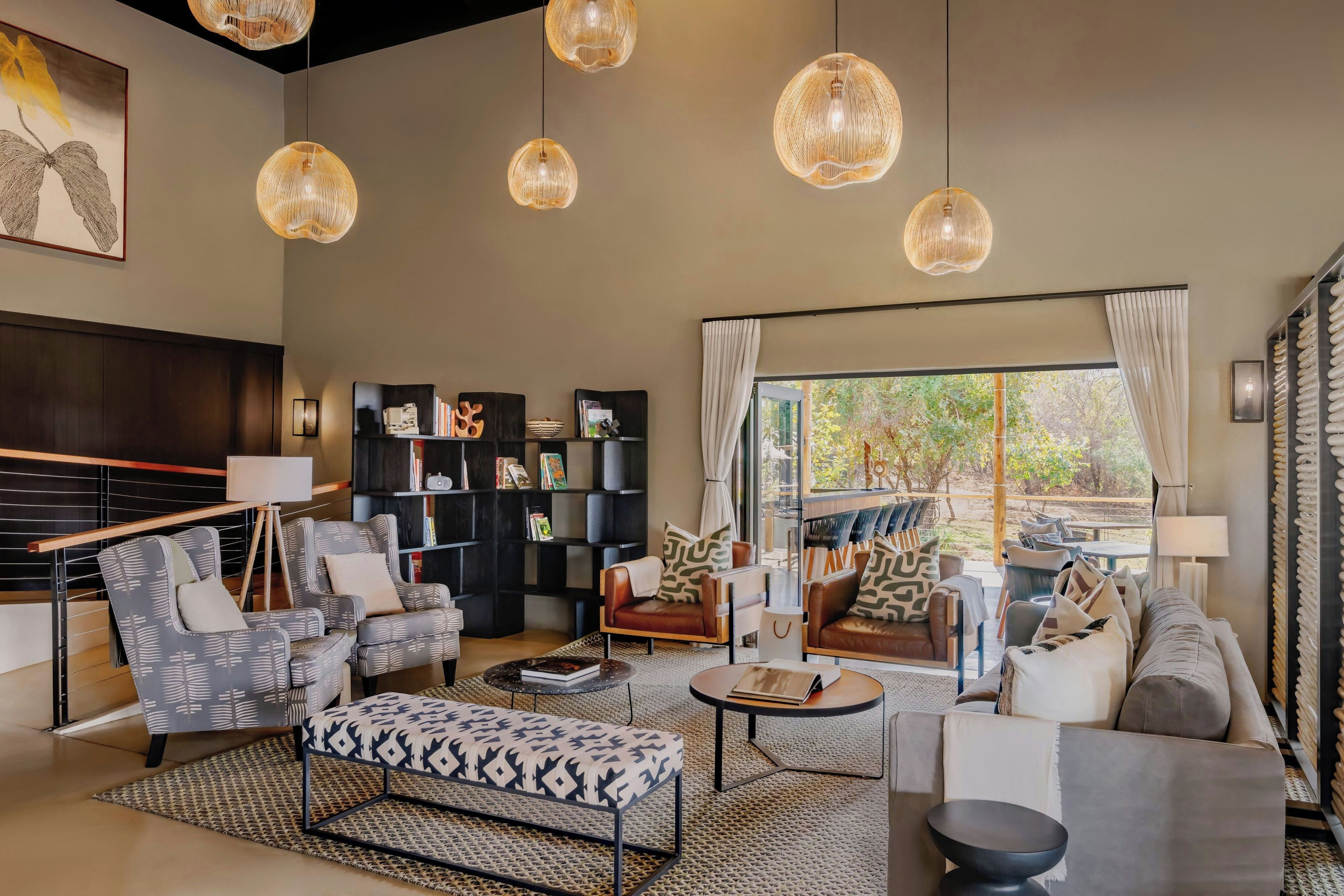 A modern living room with a sofa set, a coffee table, and a bookshelf.