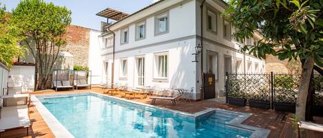 Seasonal outdoor pool, open 9:30 AM to 9:30 PM, pool loungers