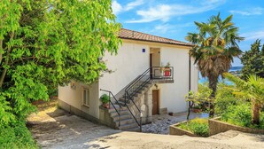 Un edificio con una scala, un portone e un balcone.