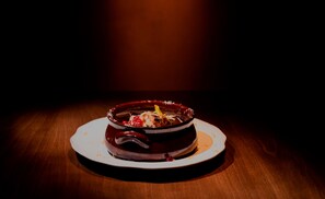 A dessert on a plate with a dark background. - Espero Royal Stay (Nafplio)