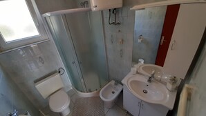 A bathroom with a toilet, bidet, shower, and sink. - Apartments Pavelic (Povile)