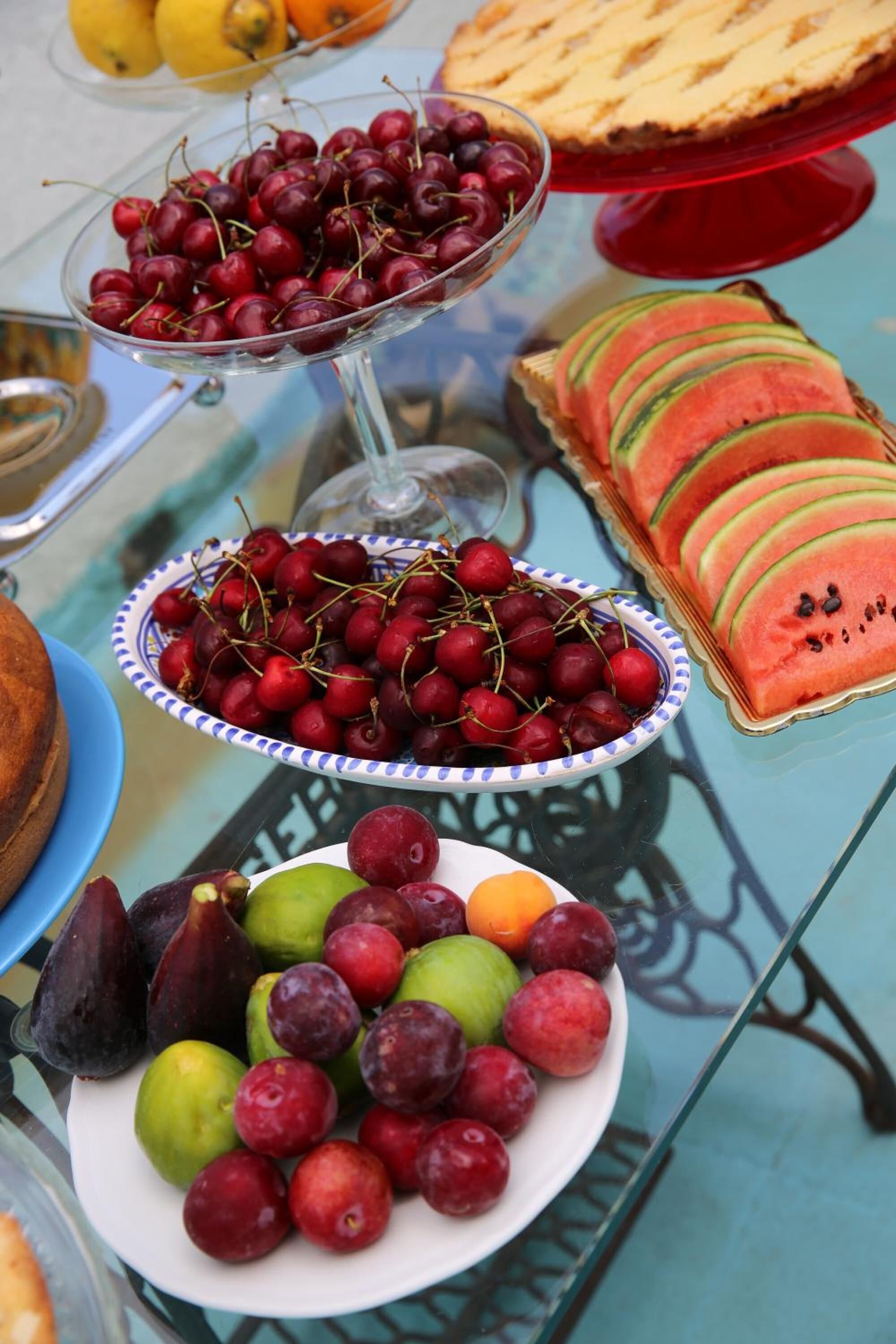 Una mesa con diversas frutas y un pastel.