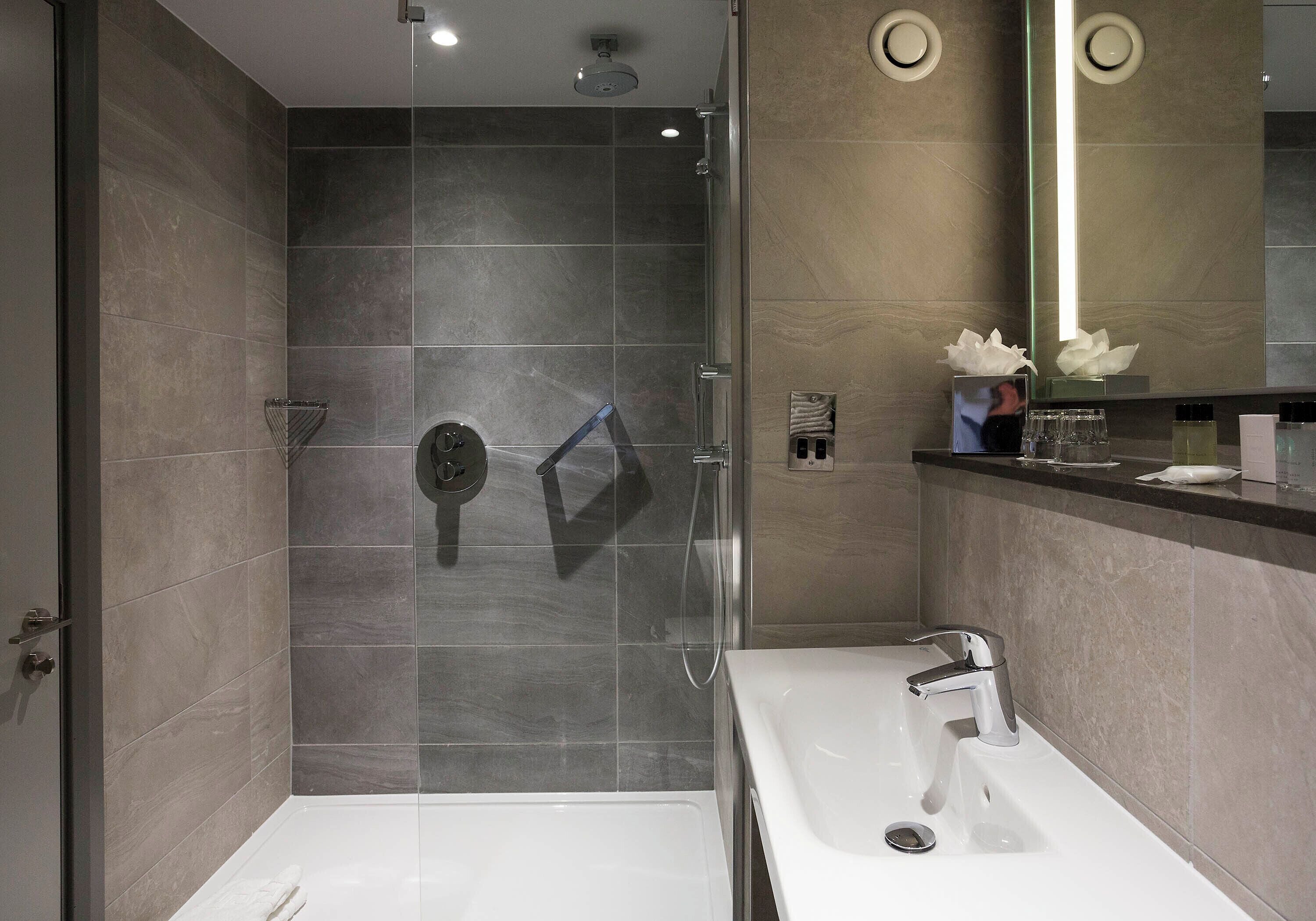 designer toiletries, hair dryer, towels, soap