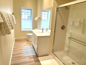 Une salle de bain avec une douche, des toilettes et un lavabo.
