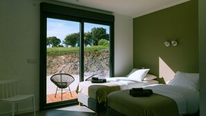 A bedroom with a bed, a chair, and a view of the outdoors. - MONTE DA FIFAS Countryside house with a pool and a magnificent view over the dam (Montargil)