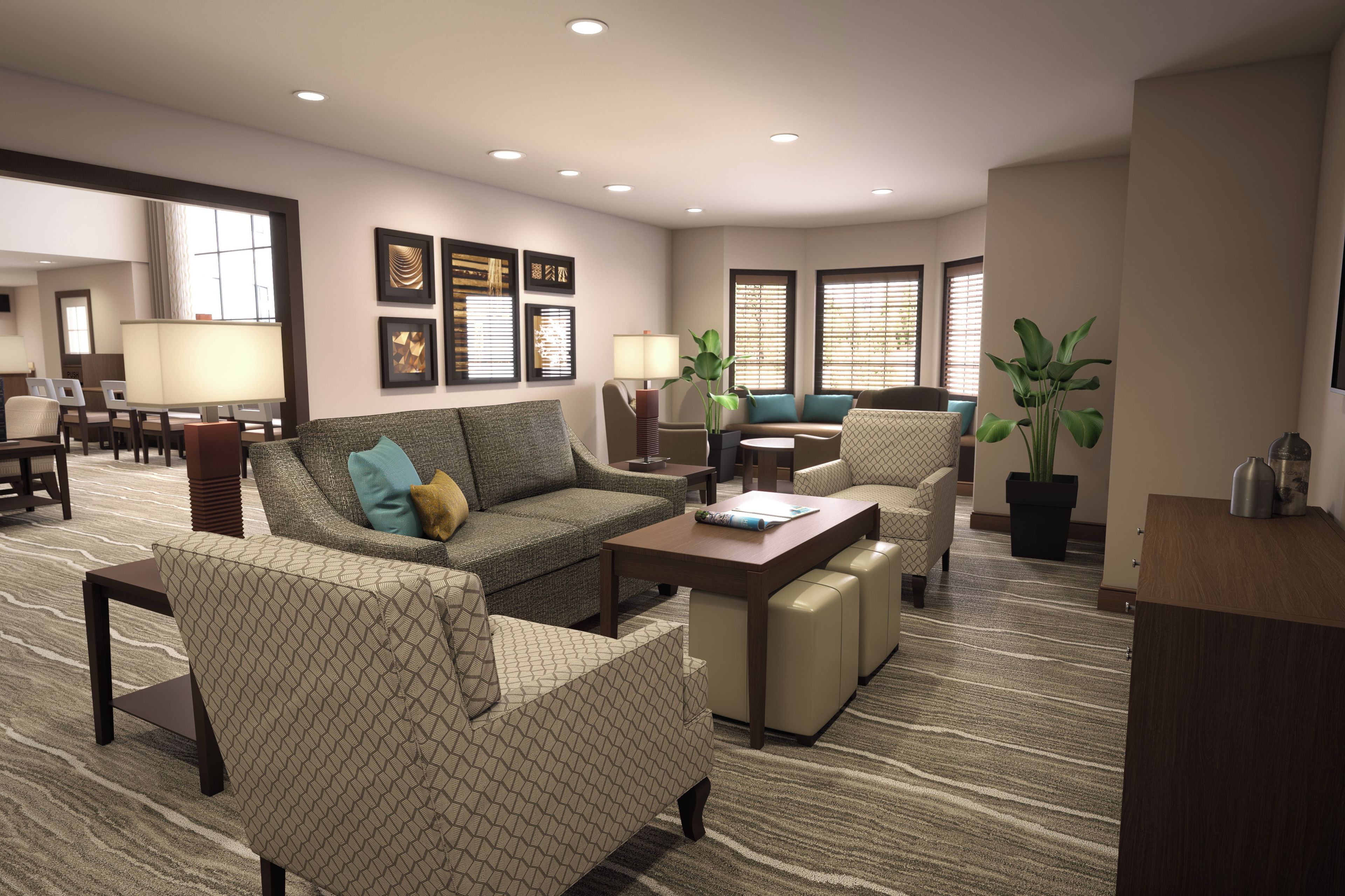 A hotel room with a sofa, armchairs, a coffee table, a dining table, and a TV.