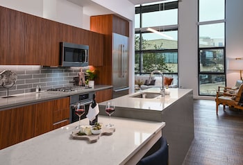 A modern building with large windows and outdoor seating. at Drey Hotel