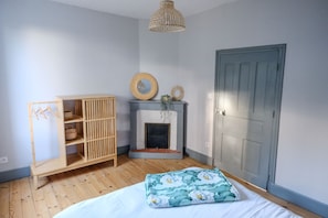 Cozy retreat with a comfortable bed, fireplace, and ample storage.