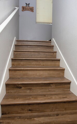 A wooden staircase with a 'WELCOME' sign above it. - Condominum (Litchfield Park)