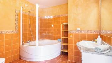 Bathtub, hair dryer, bidet, towels
