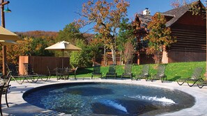 Relax by the serene pool surrounded by lounge chairs and a covered seating area.