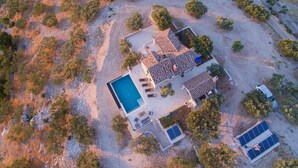 An aerial view of a house with a swimming pool, solar panels, and a garden. - Beautiful home in Postira (Postira)