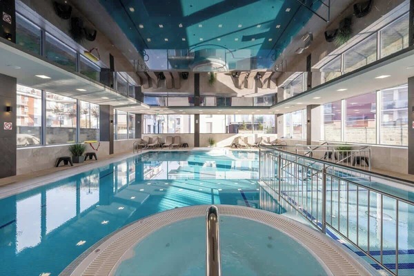 Large, modern swimming pool in the building.