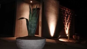 A modern building with a concrete planter and a tall, narrow structure in front. - Hotel Boutique Kpricho (SAN Antonio de las Minas)
