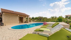 A pool area with lounge chairs and a stone building. - Nice home in Zadar with WiFi (Zadar)