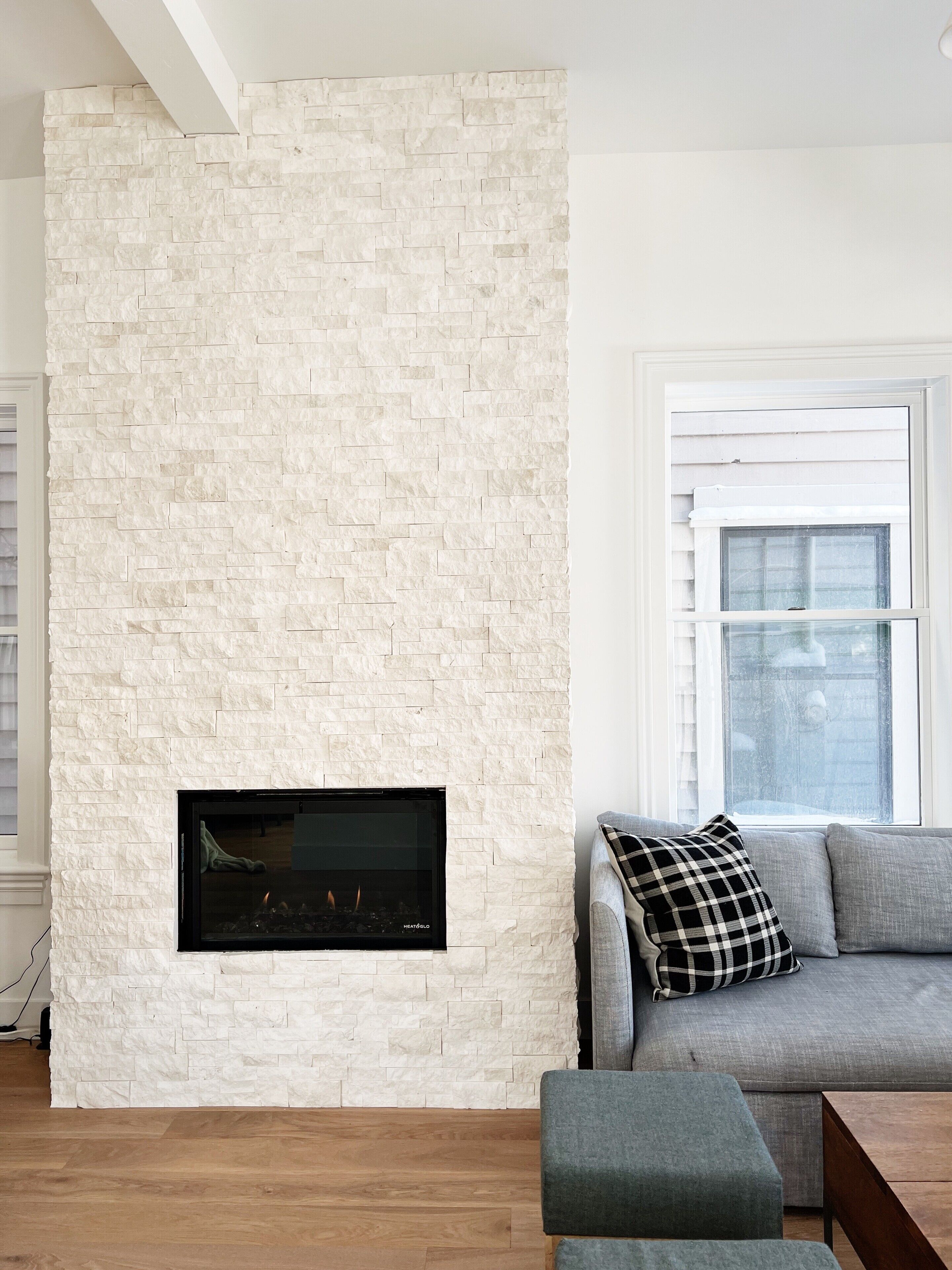 Stacked stone floor to ceiling gas fireplace