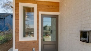 A wooden exterior with a dark door and a mailbox. - 3 Story, Roof top very close to Broadway 516 (Nashville)