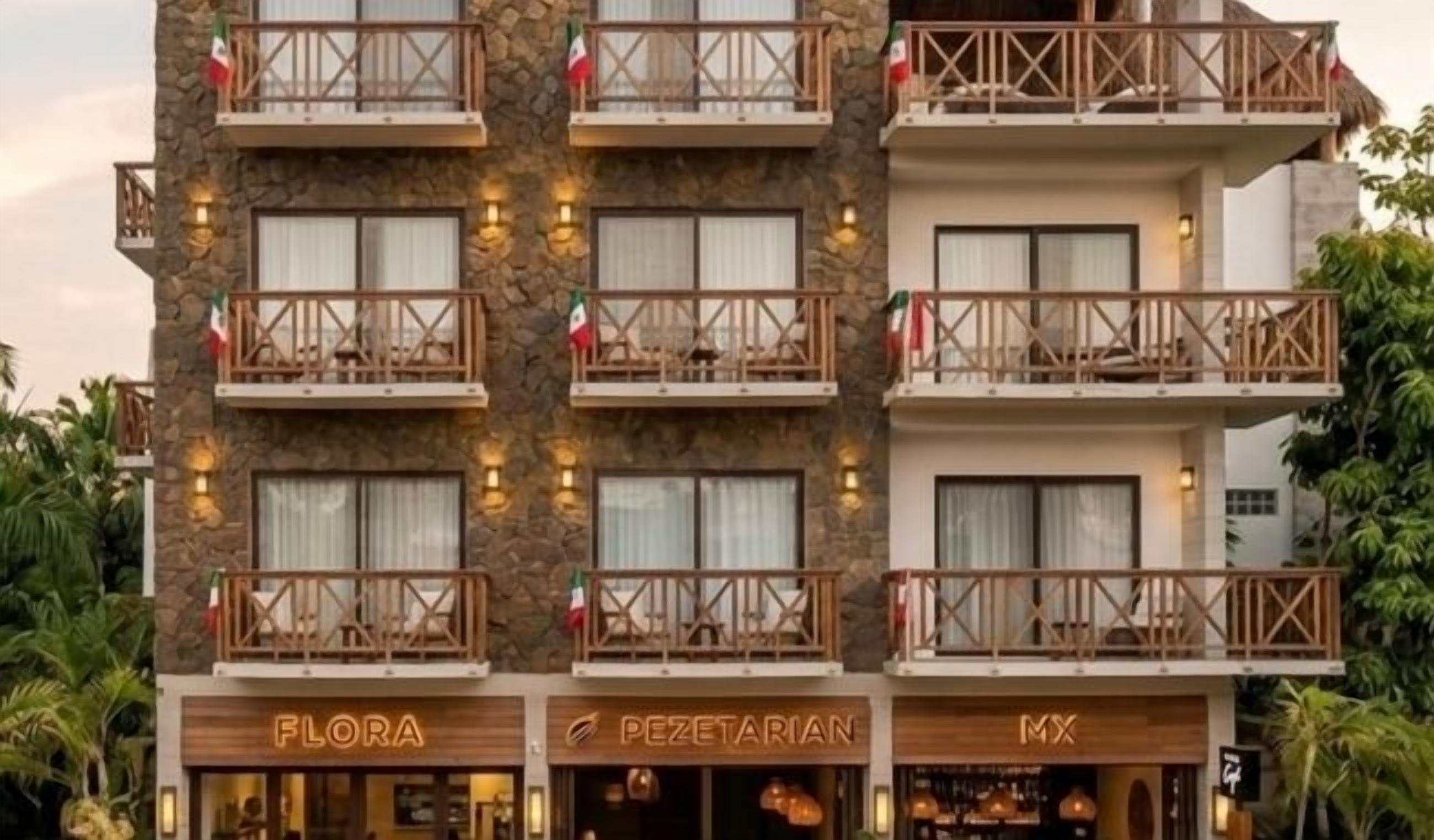 A multi-story hotel with balconies, a restaurant, and a bar.