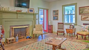 A cozy living room with a fireplace, comfortable seating, and a television.
