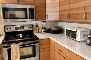 Enjoy cooking in this well-equipped kitchen with a microwave, oven, toaster, and blender.
