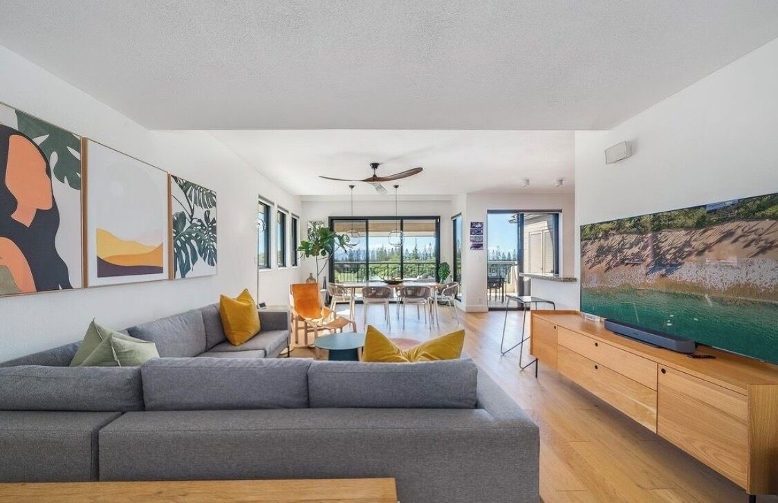 Modern living space with large windows and Kapalua Bay golf course outlook