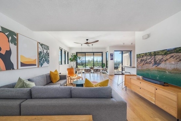 Modern living space with large windows and Kapalua Bay golf course outlook