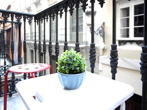 Enjoy a peaceful moment on the balcony with a beautiful view of the city.