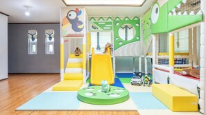 A children's play area with a slide, climbing wall, and various play structures. - Gapyeong Yeoul Kids Pension (Gapyeong)