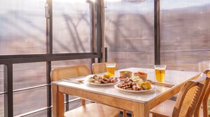 A table set with plates of food, drinks, and a window with a view. - Gapyeong Santa Maria Dog-friendly Privat (Gapyeong)