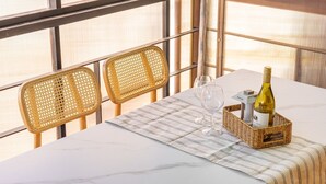 A table set with a bottle of wine, two glasses, and a wicker basket with a bottle label. - Gapyeong Santa Maria Dog-friendly Privat (Gapyeong)