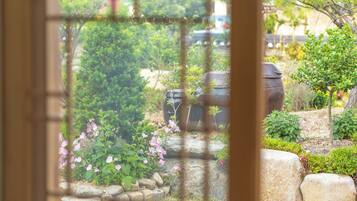 A garden with a variety of plants and a large pot.