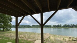 A covered outdoor area with a view of a river and trees. - Riverfront Retreat & Fisherman's Gold, on TN River (Savannah)