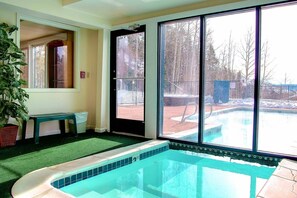 A swimming pool with a view of a backyard and a door leading outside. - Steps to Trails-Pool-Hot Tub-W/D in Unit-Grill (Steamboat Springs)