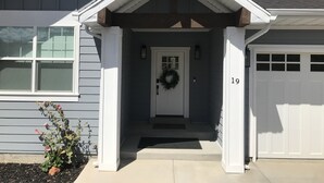 A residential house with a front porch, a garage, and a number '19' on the garage door. - Blue Lake Retreat - fully-landscaped home sits on 2nd tee of Bear Lake G.C. (Garden City)