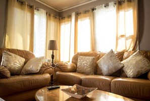 Relax in this inviting living room with a comfortable sofa set, coffee table, and lamp.
