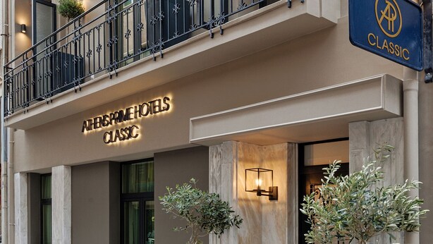 A hotel entrance with a classic sign, a balcony with plants, and a well-lit facade. - Classic Hotel by Athens Prime Hotels (Athens)
