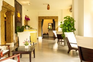 A spacious lobby with a reception desk, seating area, and a large potted plant. - Pax Ana Doc Let Resort & Spa (Ninh Hoa)