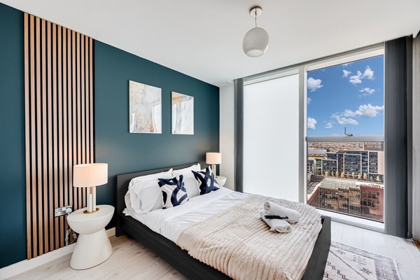 The bedroom has a double bed with fresh linen and towels provided.