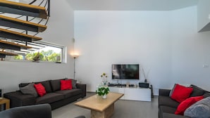 A modern living room with a sofa set, a coffee table, and a flat-screen TV. - Villa Elsa with 4 bedrooms (Krnica)