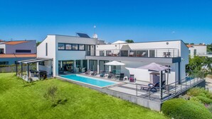 A modern two-story house with a swimming pool, outdoor seating, and a covered patio area. - Villa Elsa with 4 bedrooms (Krnica)
