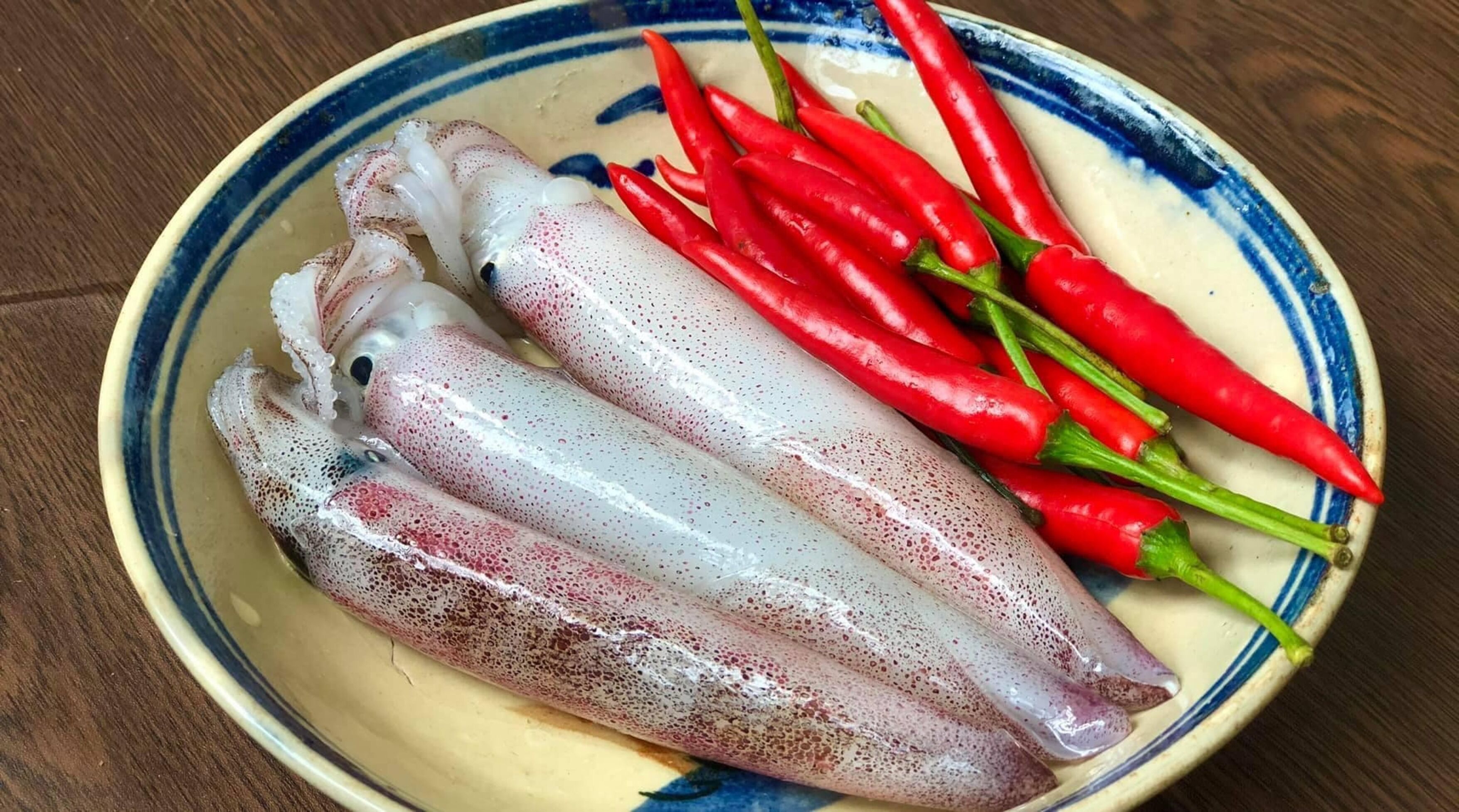 A plate with squid and red chili peppers.