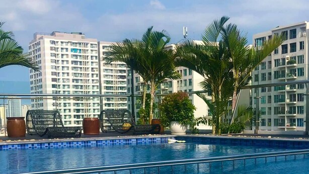A poolside dining setup with a variety of dishes, including a roasted chicken, salad, and avocado. - Ha Long New Century Hotel (Bai Chay)