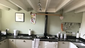 A kitchen with a stove, oven, and various kitchen utensils. - Impeccable Cottage Suitable for 2 Adults & 1 Child (York)