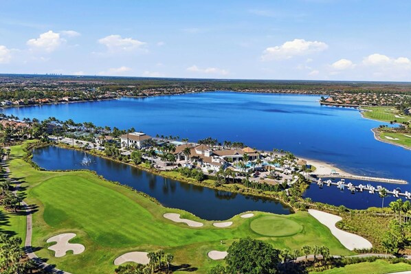 A golf course with a large lake, residential areas, and a marina.