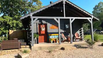 Rustic building with a charming entrance and adjacent outdoor seating area.