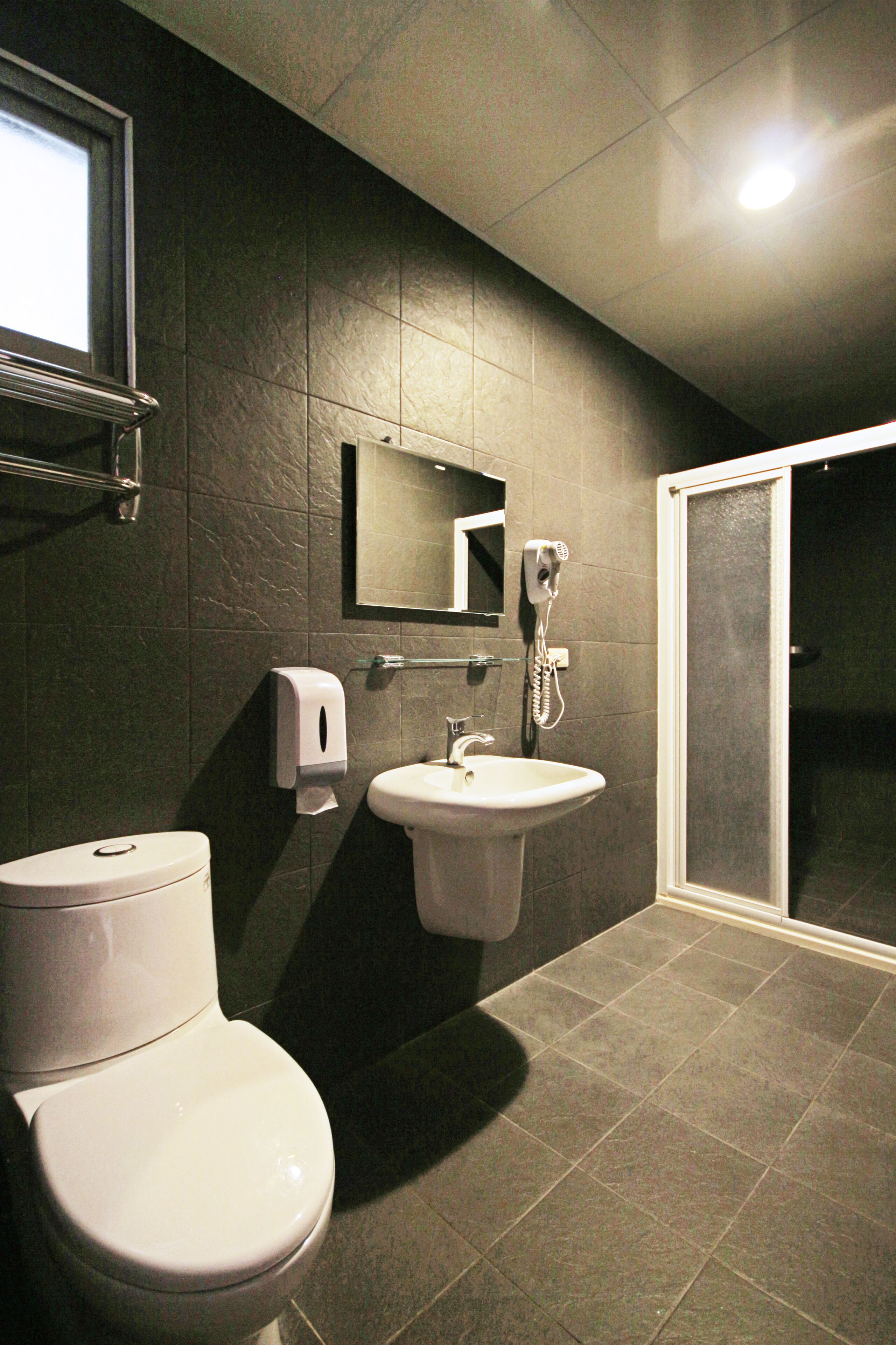 deluxe triple room | bathroom | shower, hair dryer, shampoo, toilet paper