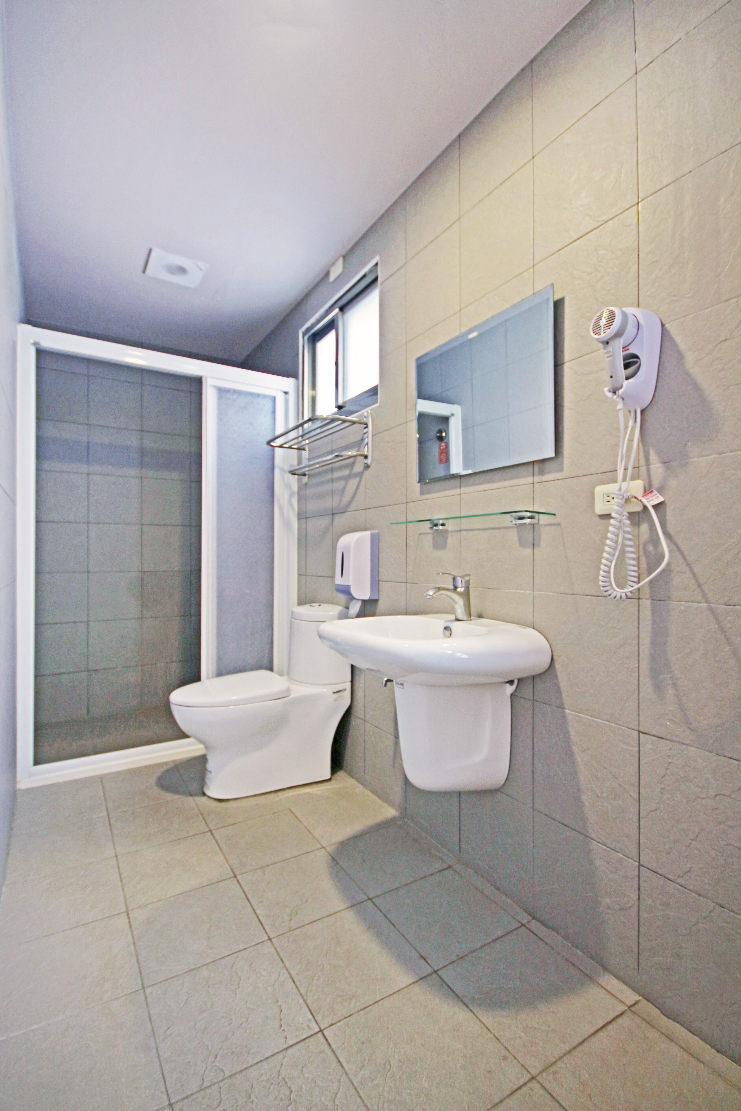 shower, hair dryer, shampoo, toilet paper