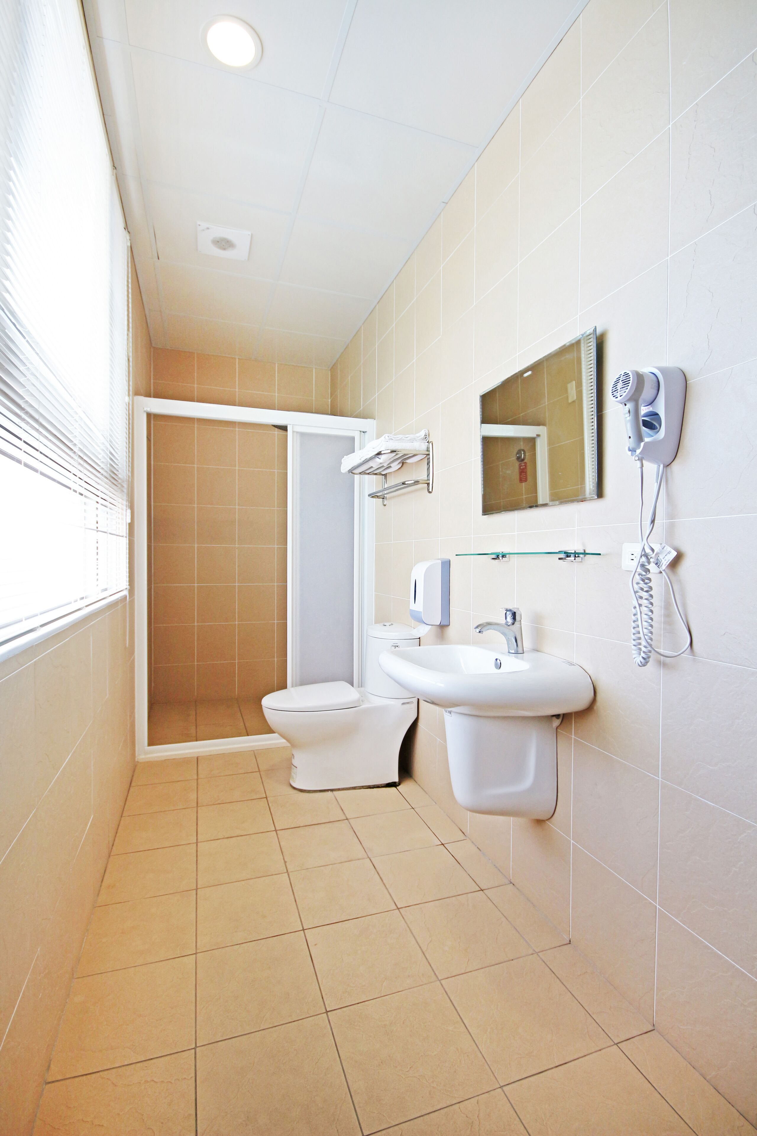 signature quadruple room, 2 double beds | bathroom | shower, hair dryer, shampoo, toilet paper